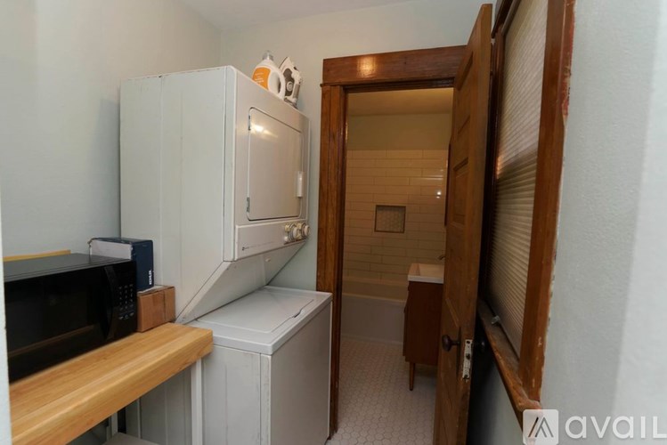 A kitchen area with a microwave, oven, and refrigerator.