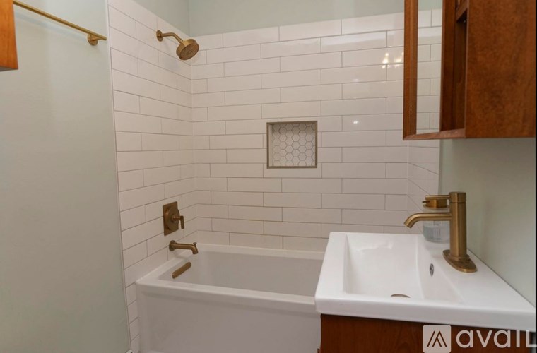 A white bathroom with a white tub and sink.