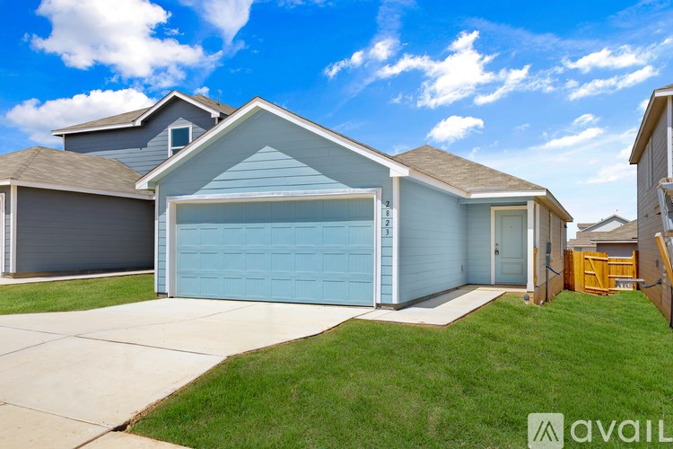 A house with a blue garage door is for sale.