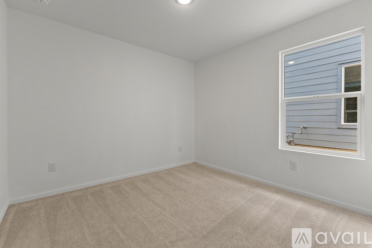 A room with a window and carpeted floor.