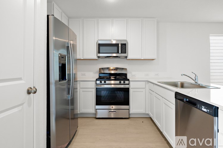 A kitchen with white cabinets and stainless steel appliances.