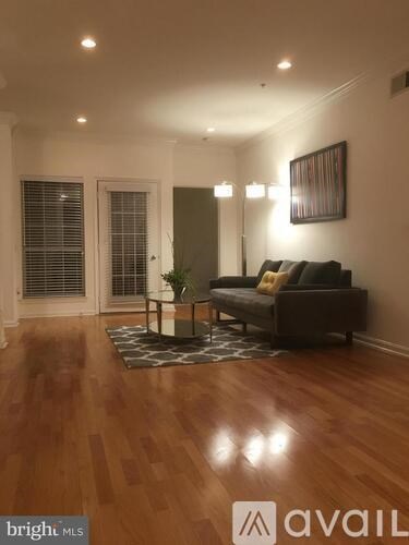 A living room with a couch and a rug.
