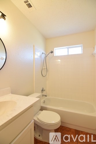 A bathroom with a toilet, sink, and bathtub.