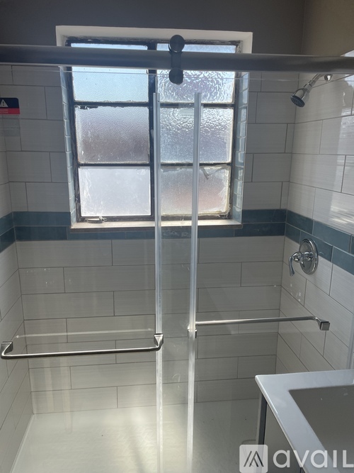 A bathroom with a window and a shower.