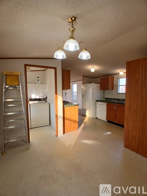 A room with a ceiling fan and wooden flooring.