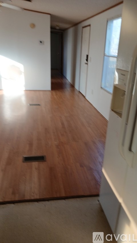 A kitchen with wooden cabinets and a white refrigerator.