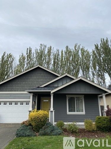 A house with a garage and a driveway in front.