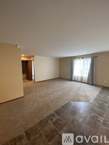 A kitchen with black cabinets and a white island.