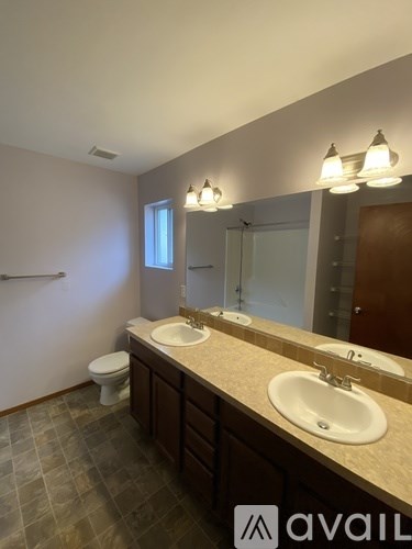 A modern kitchen with black cabinets and a white island.