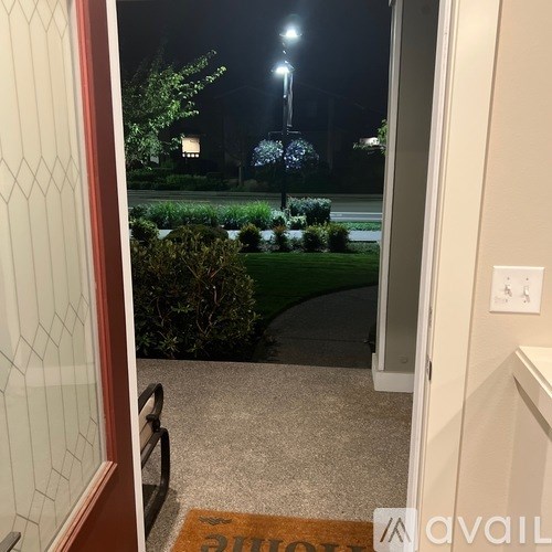 A view from a doorway looking out to a nighttime garden.