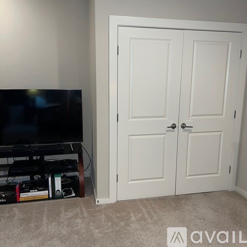 A white double door is closed.