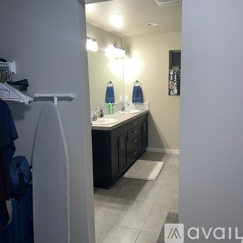 A bathroom with a sink, mirror, and cabinets.