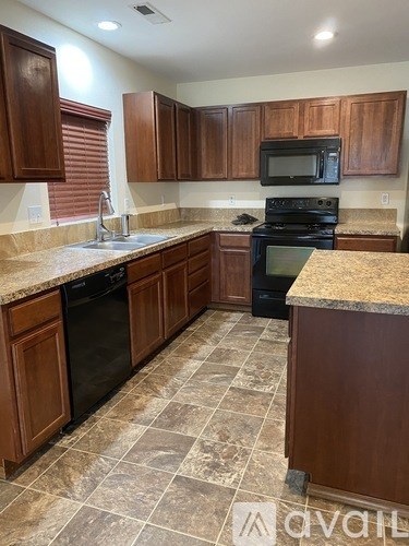 A room with a keyboard, speaker, and a guitar painting on the wall.