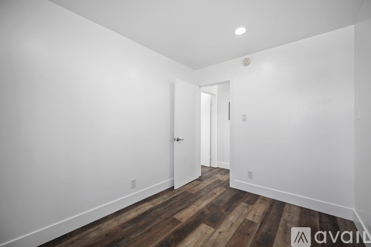 A room with wooden floors and white walls.