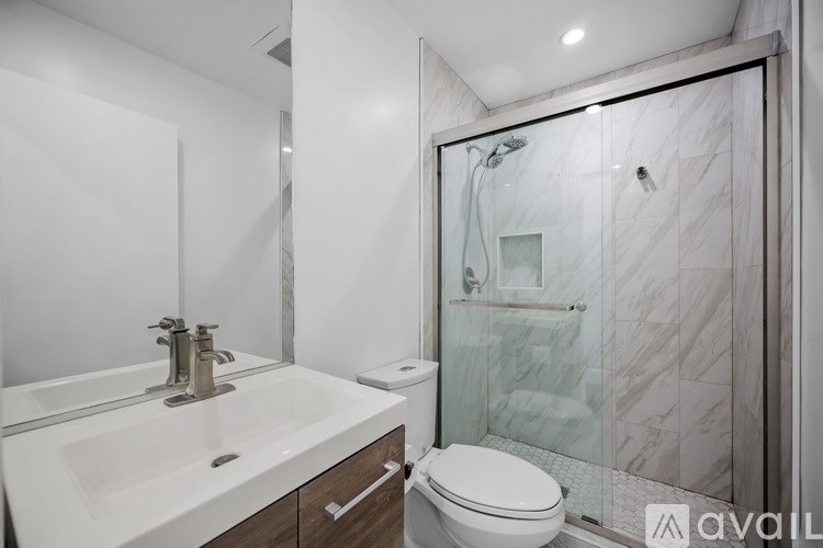 A bathroom with a sink, toilet and shower.