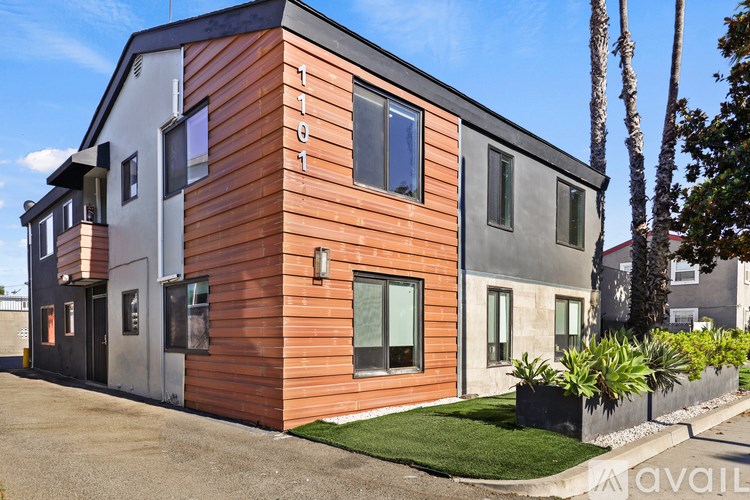 A modern house with a wooden exterior and a grey roof.