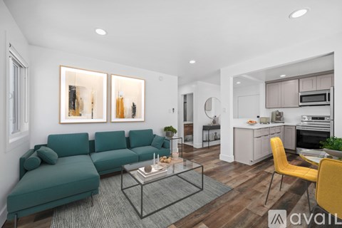 A modern living room with a green sofa and a yellow chair.