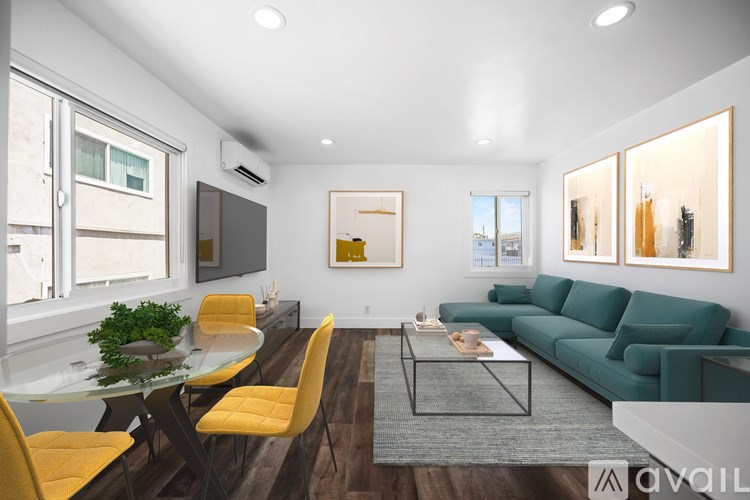 A modern living room with a glass table and yellow chairs.