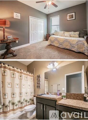 A bedroom with a bed, a table with a lamp, and a bathroom with a shower curtain.