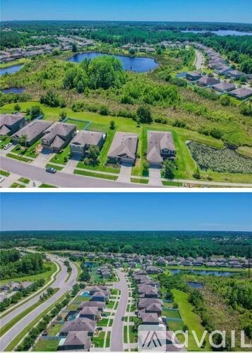 A bird's eye view of a residential area with houses and a river.