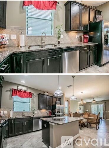 A kitchen with black cabinets and a red curtain.