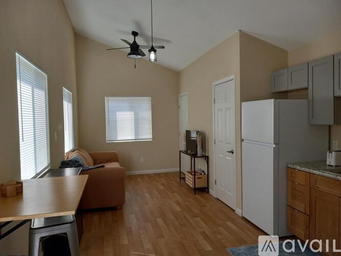 A kitchen with a white refrigerator and wooden cabinets.