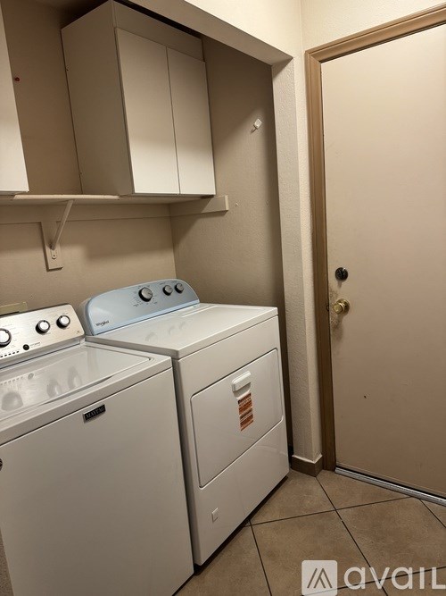 A small laundry room with a washer and dryer.
