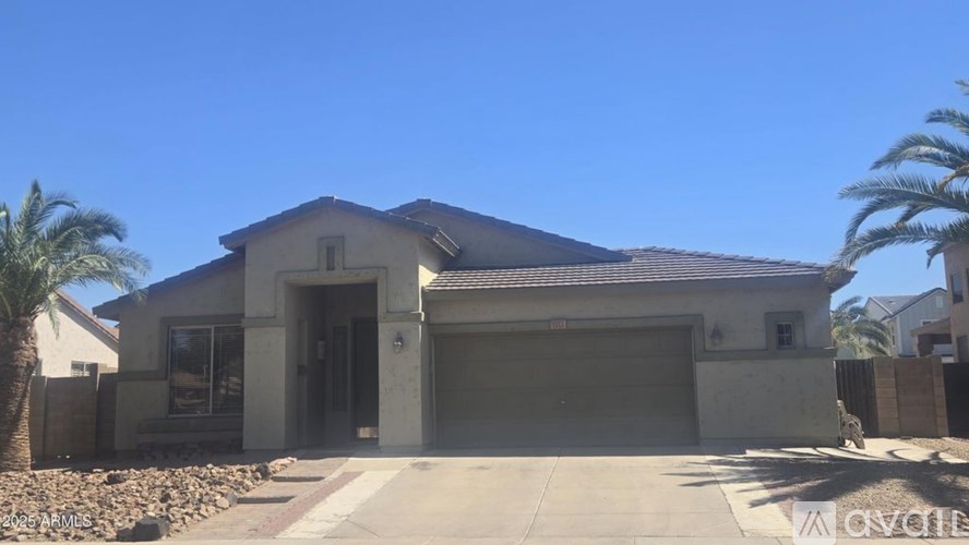 A house with a garage and a driveway in front of it.