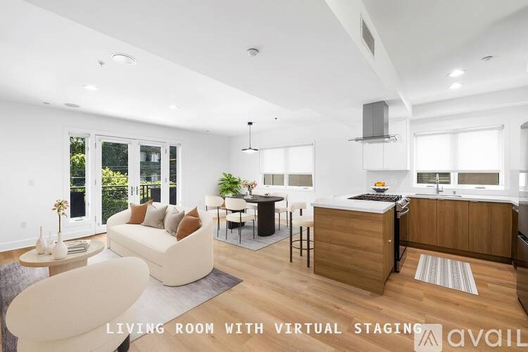 A modern living room with a kitchen area in the background.