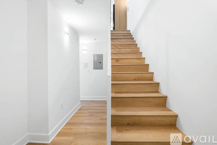 A wooden staircase leads up to a door at the top.