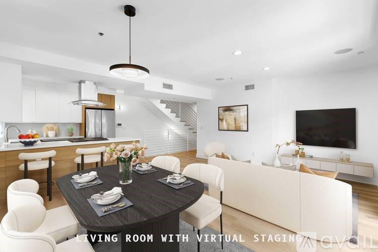 A modern living room with a dining table set for six.