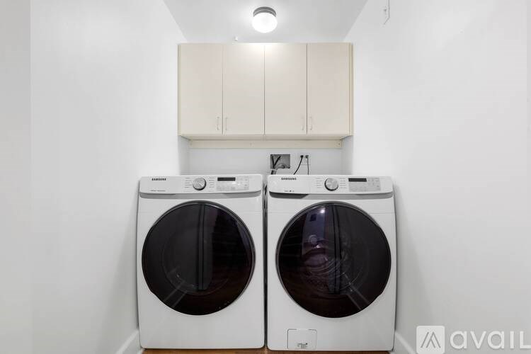 Two front loading washing machines in a laundry room.
