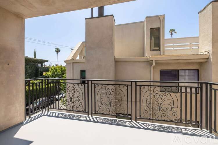 A house with a balcony and a metal railing.