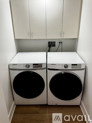 Two front loading washing machines in a laundry room.