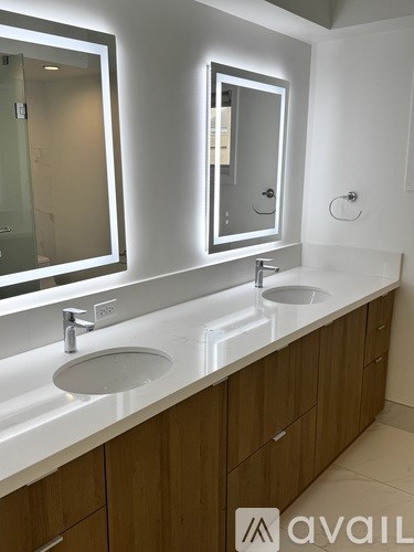 A bathroom with two sinks and two mirrors.