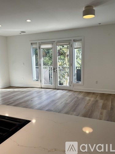 A room with a marble countertop and a large window with a view of trees.