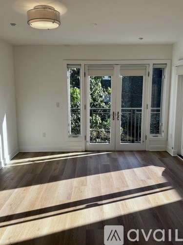 A room with a sliding glass door leading to a balcony.