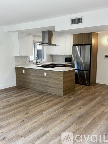 A modern kitchen with a stainless steel range hood.