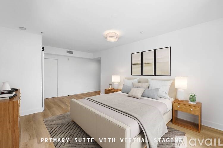 A bedroom with a bed, nightstand, and lamp.