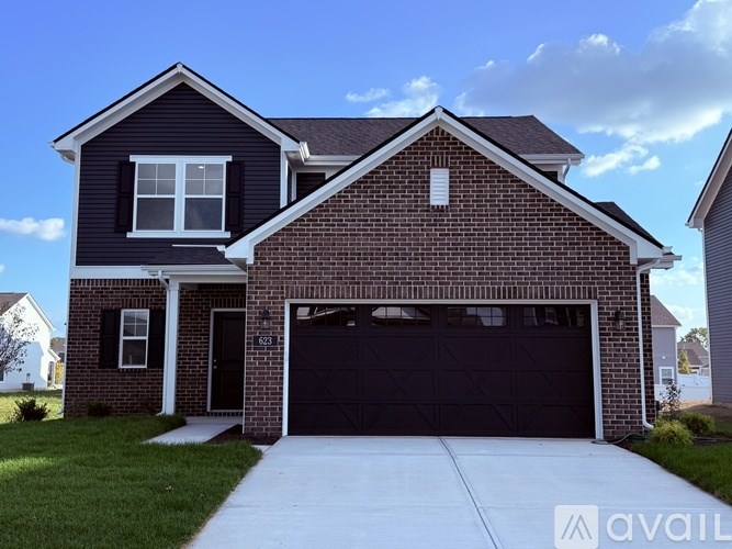 A two-story house with a garage is for sale.