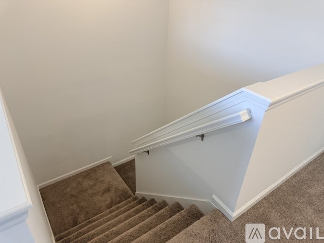 A staircase with a carpeted runner and white risers.