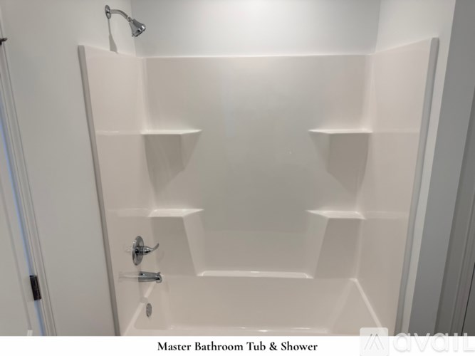 A room with a carpeted floor and a large window overlooking a residential area.