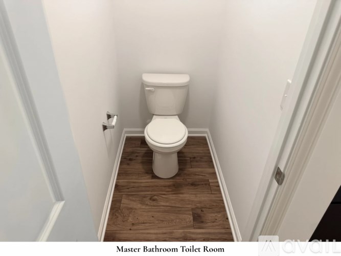 A room with a carpeted floor and a white door.