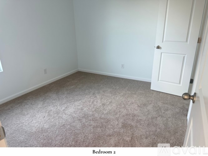 A white bathroom with a bathtub and shelves.