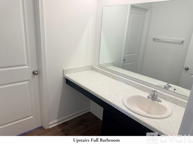 A room with a carpeted floor and a white wall.