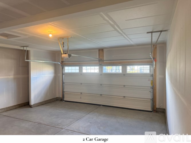 A white closet with a shelf and a door.