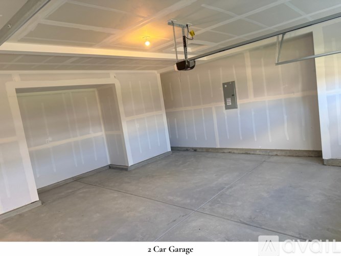 A white door is in the middle of a room with a light on the ceiling.