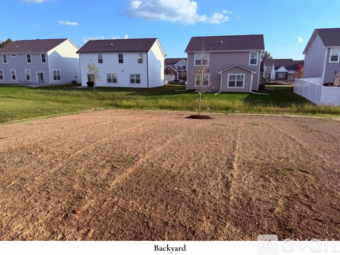 A room with a carpeted floor and a white door.