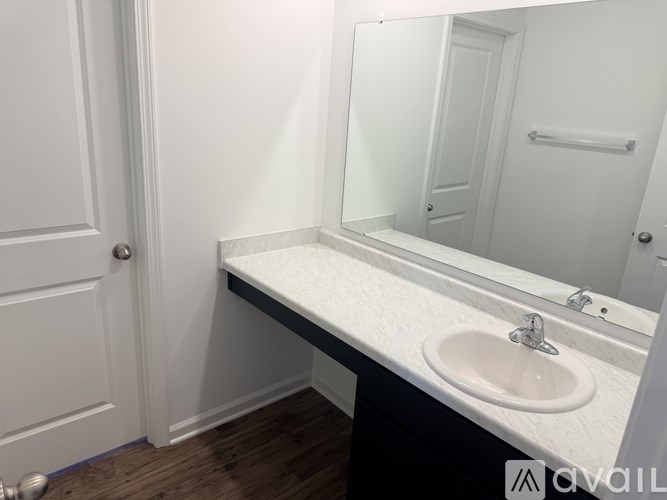 A bathroom with a sink and mirror.