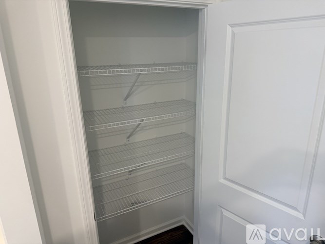 Empty white refrigerator with shelves inside.